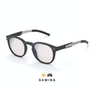 Lunettes gaming anti lumière bleue rondes et noires avec verres clairs, branche en métal et embout en silicone noir sur fond blanc